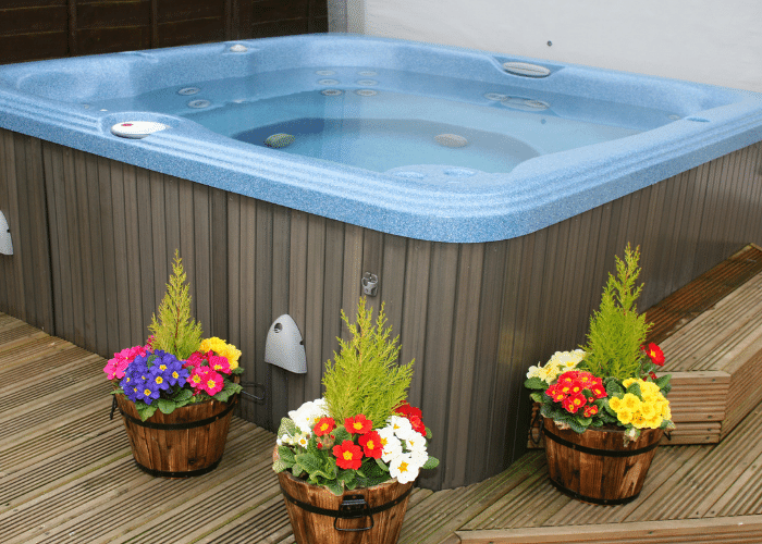 Hot tub surrounded by flowers in planters