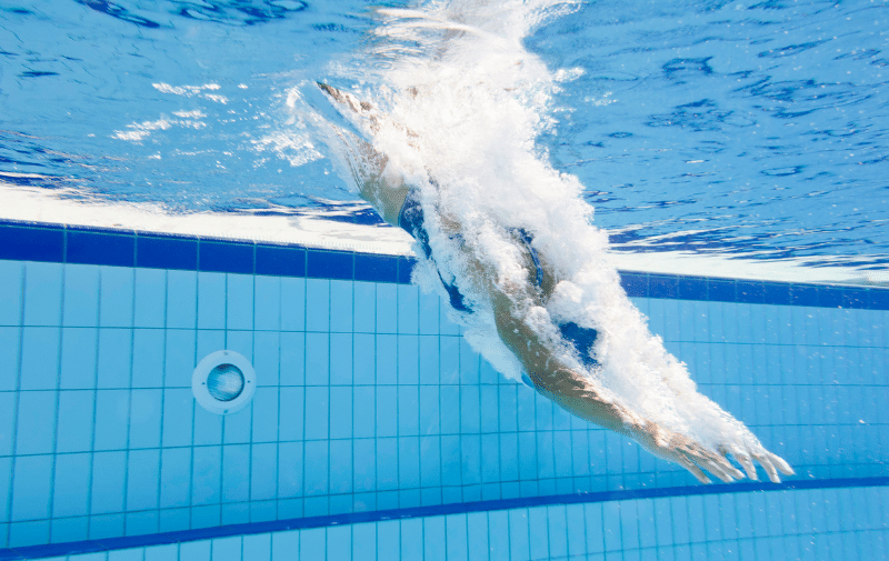 Person diving into a swimming pool
