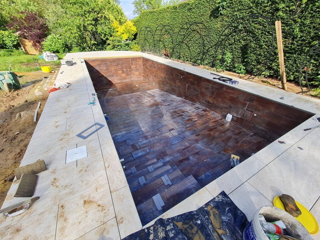 Rectangle swimming pool with copper tiles mid construction