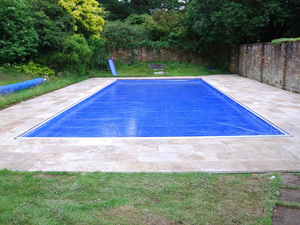 Blue pool safety cover on a pool