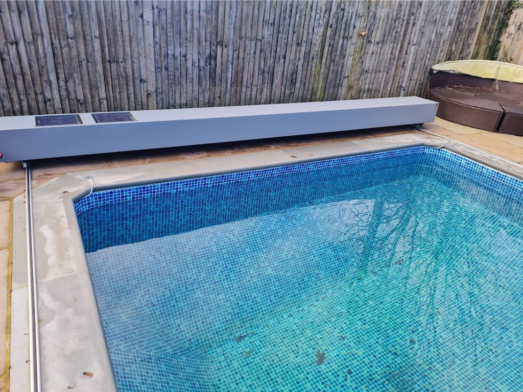 Swimming pool with grey above ground pool safety cover storage