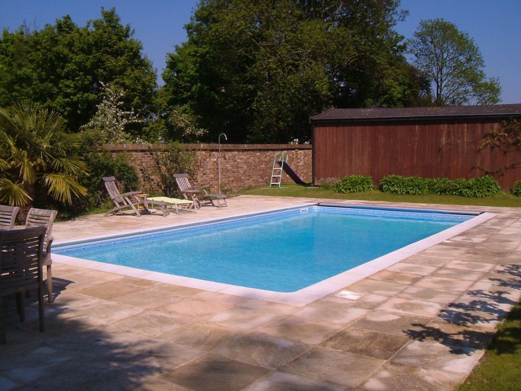 A rectangle outdoor swimming pool in a back garden