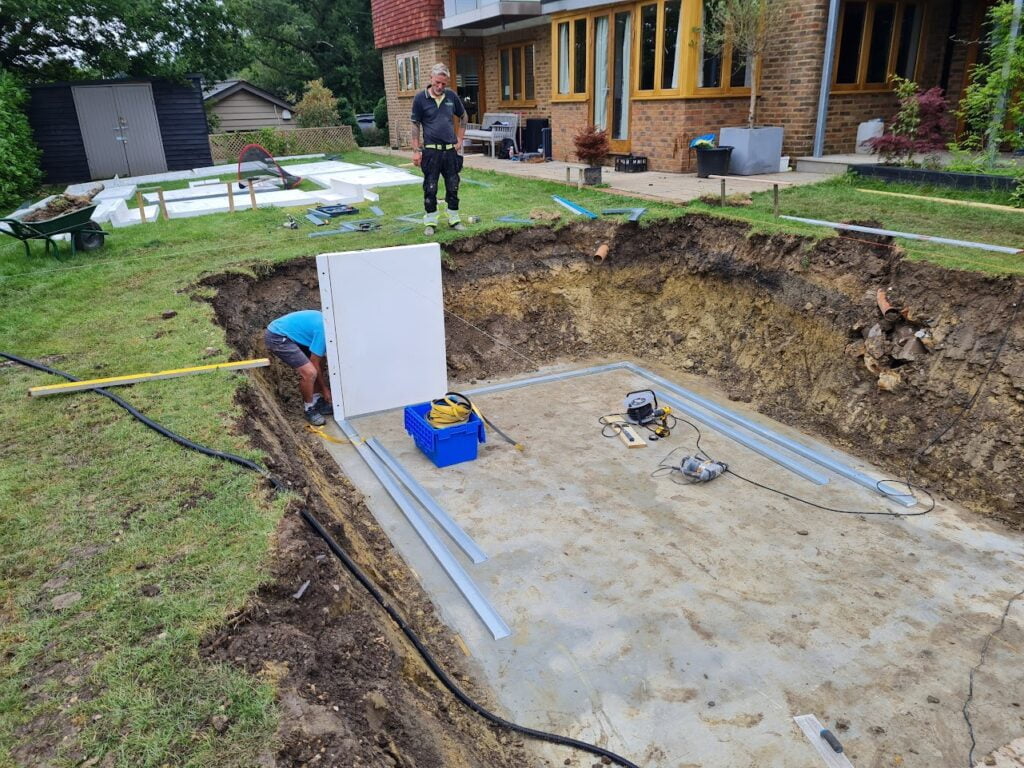 A swimming pool being constructed and HeatForm panels being fitted into a rectangle shaped hole