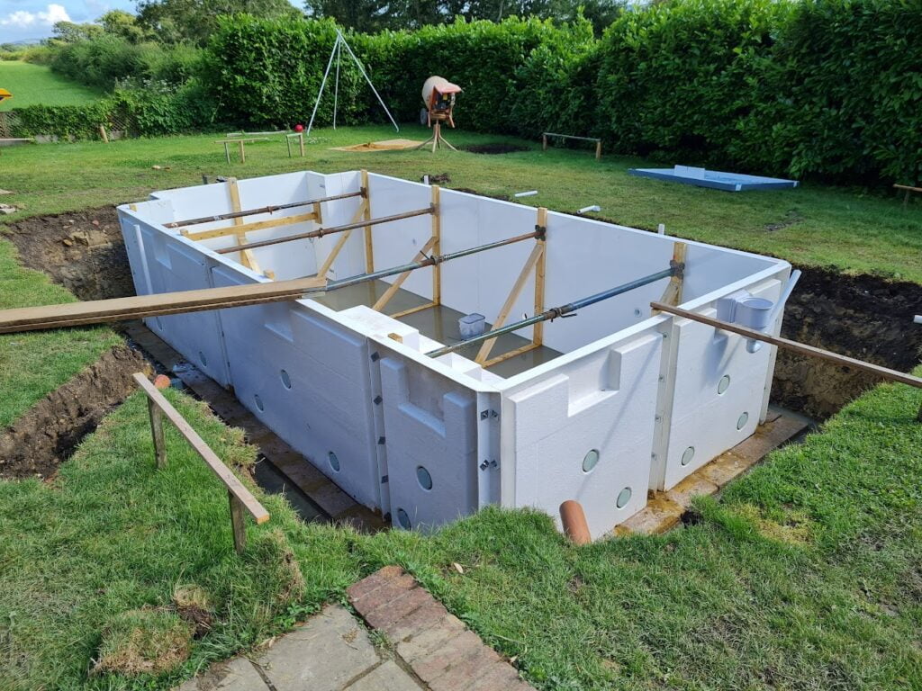 An outdoor swimming pool being constructed out of heatform panels