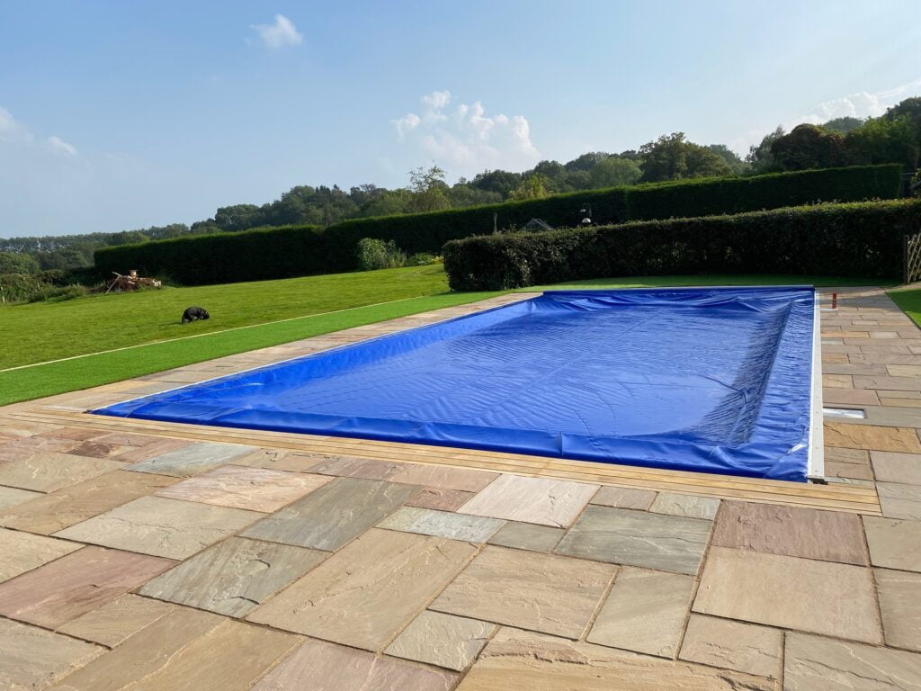 Outdoor swimming pool with blue pool cover