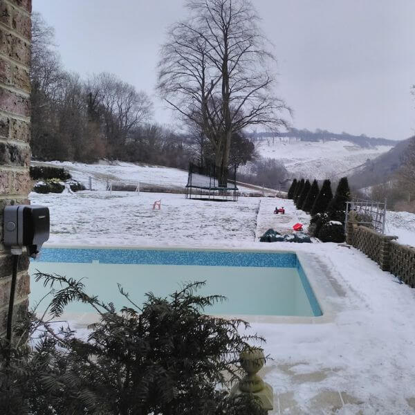 Swimming pool surrounded by snow