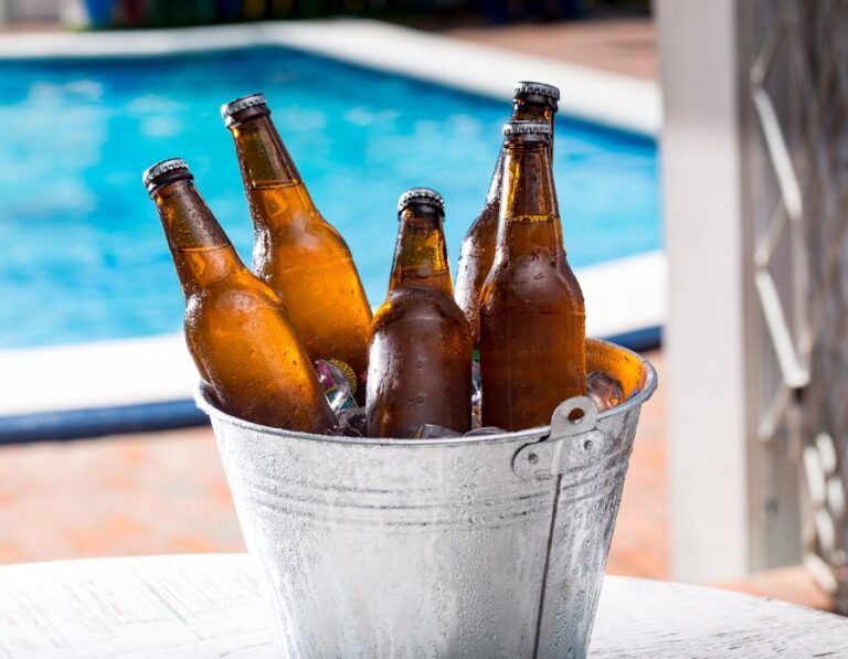 Beers in a cool bucket next to a pool