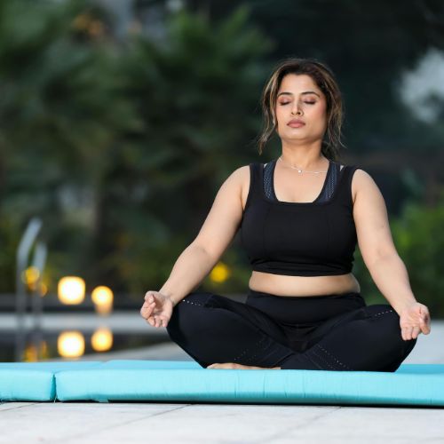 woman meditating by pool
