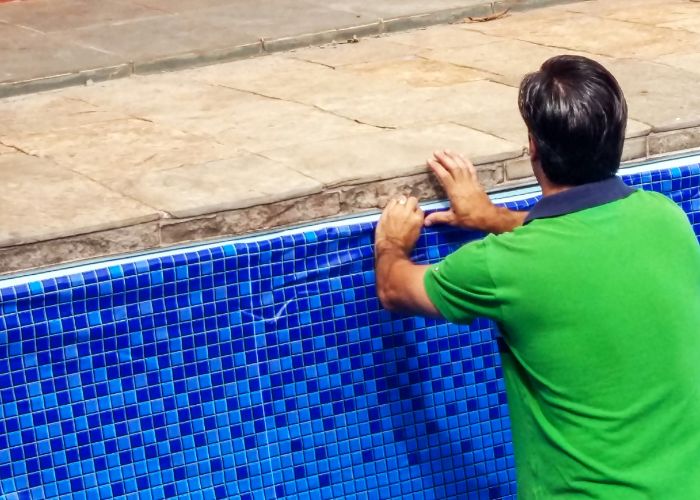 man replacing pool liner