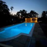 completed pool refurbishment with lights in the evening